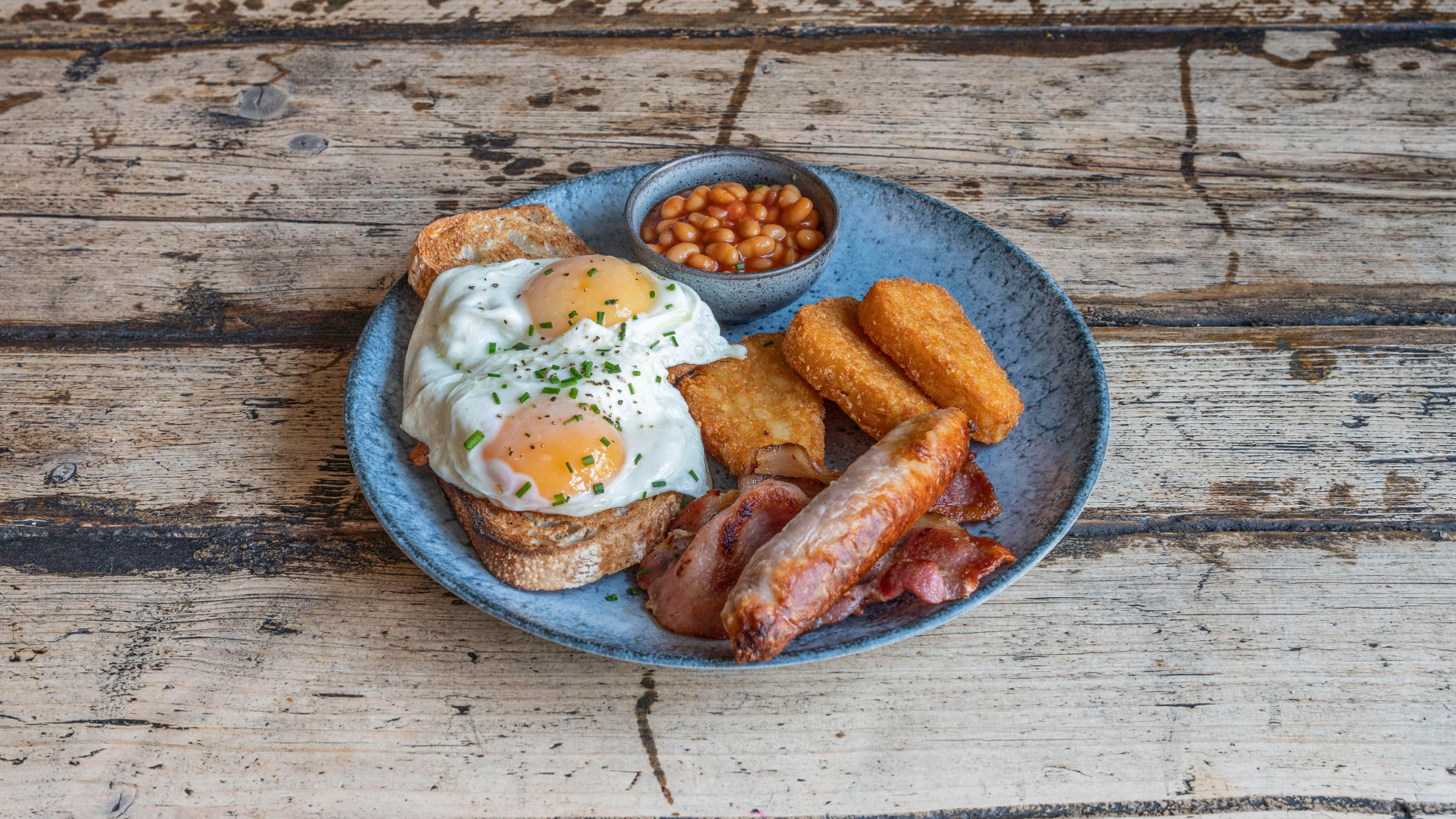 Igloo breakfast with eggs, bacon, sausage, beans and hash browns